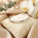 Personalized Silver Finish Adjustable Name Kada on cream fabric