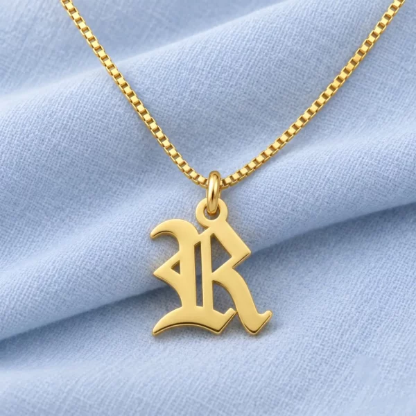 Old English Letter Pendant displayed on pale blue fabric