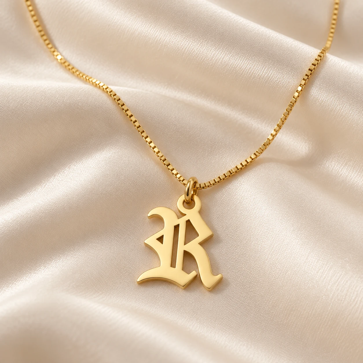 Old English Letter Pendant - With a chain on cream fabric Old English Letter Pendant with a chain on cream fabric