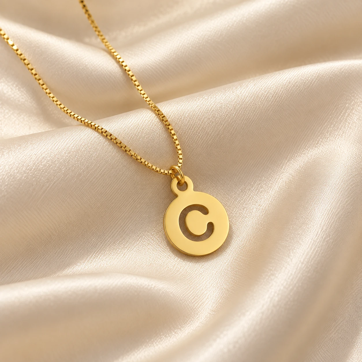 Round Letter Pendant - With a chain on cream fabric Round Letter Pendant with a chain on cream fabric