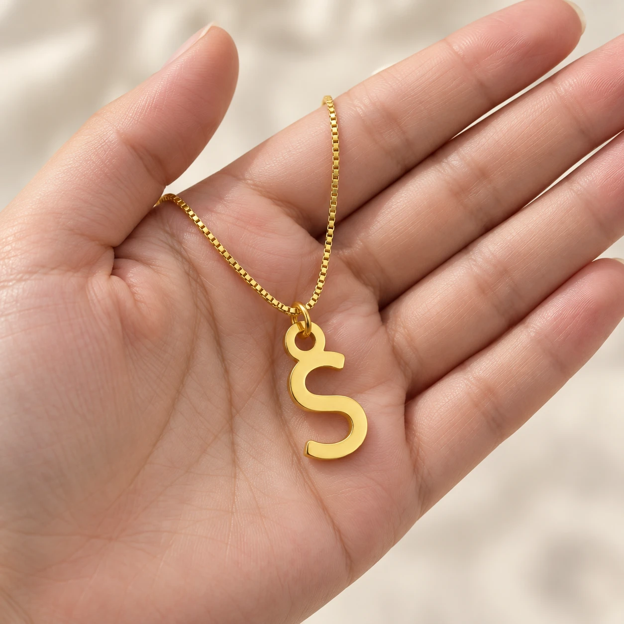 Simple Letter Pendant - With a chain held in a hand Simple Letter Pendant with a chain held in a hand