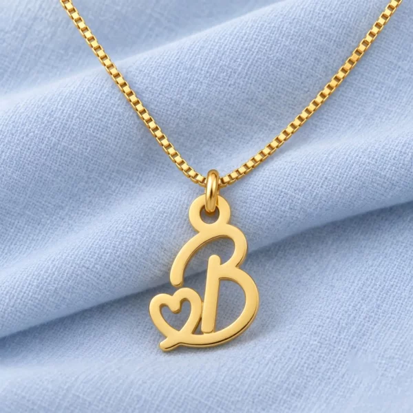 Small Heart Letter Pendant displayed on pale blue fabric