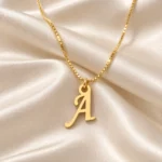 Stylish Letter Pendant with a chain on cream fabric