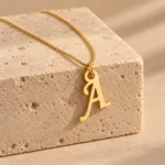 Stylish Letter Pendant with a chain on a stone display