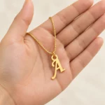 Stylish Letter Pendant with a chain held in a hand