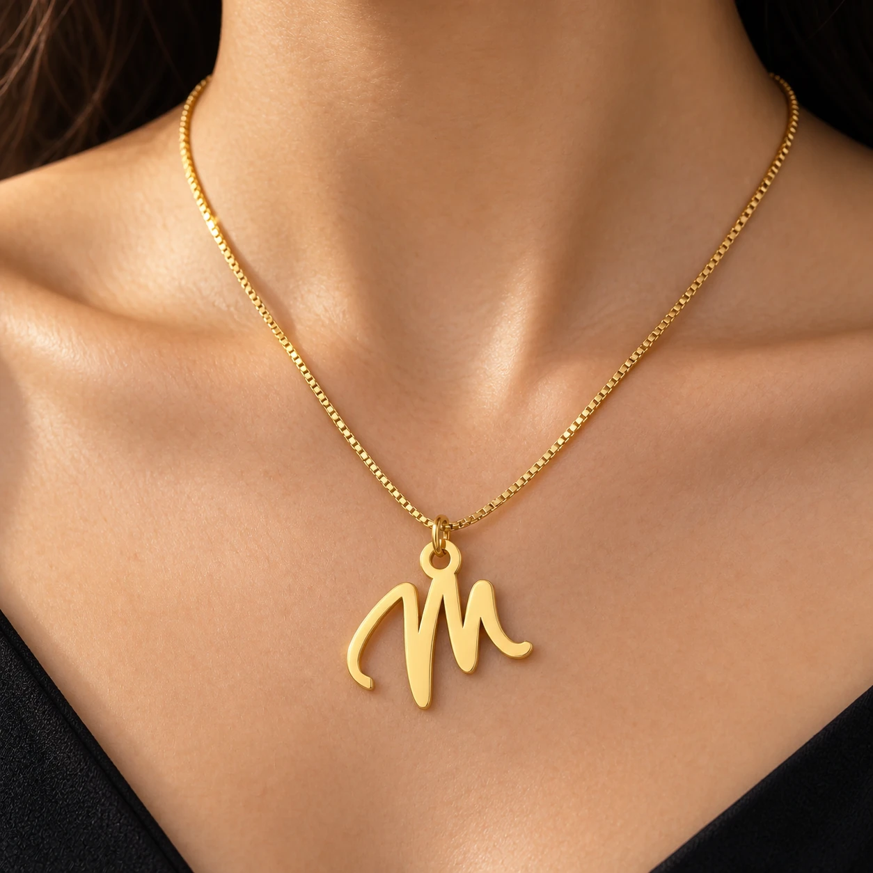Stylish Letter Pendant M - model-worn Gold script M letter pendant with fine box chain - model-worn