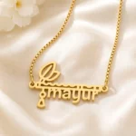 Gold-tone flute and feather name pendant on ivory satin