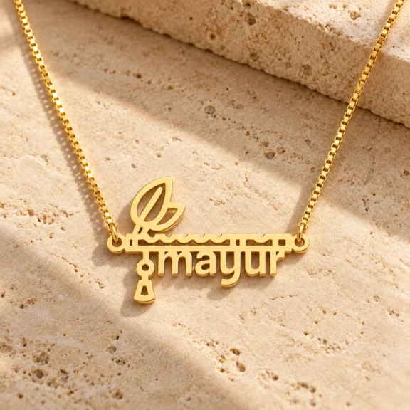 Flute and Feather Name Pendant on a rough stone surface