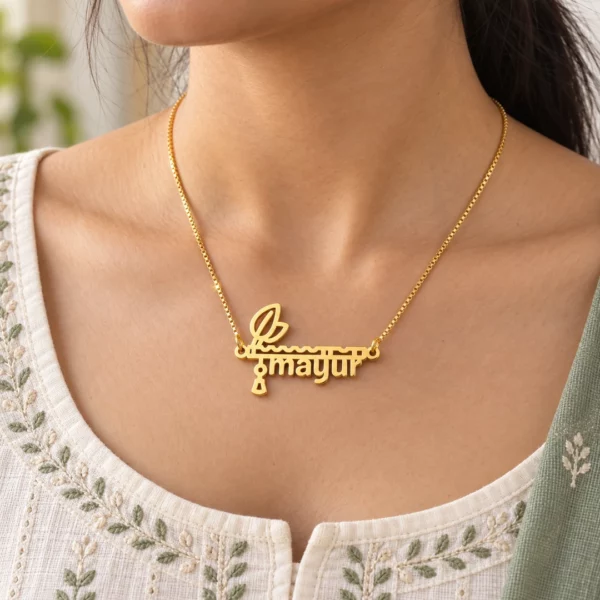 Gold flute design mayur name necklace styled with an ivory and sage kurti