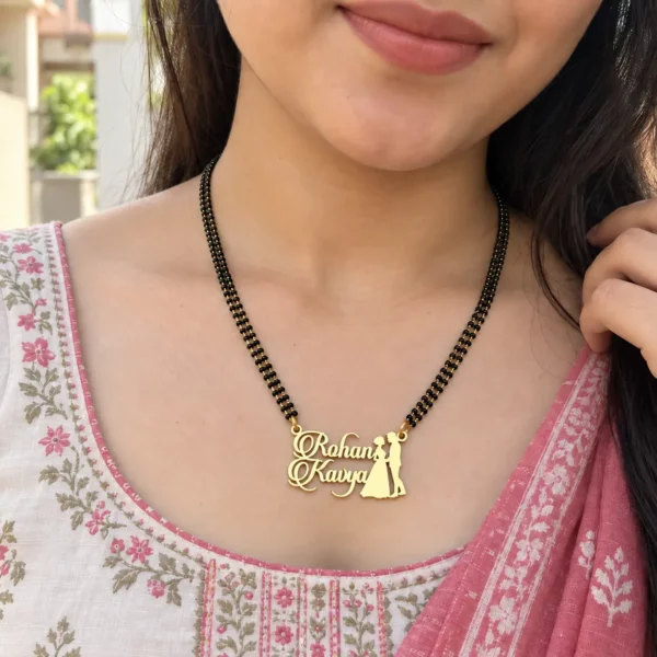 Rohan Kavya couple name necklace with black-bead chain worn with a floral outfit