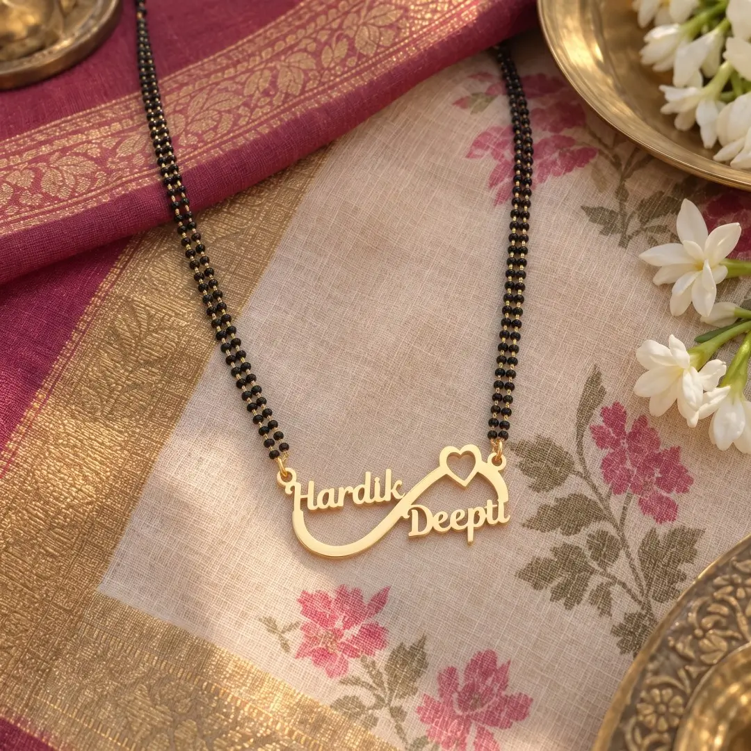 Infinity Heart Couple Name Mangalsutra Pendant - With a black-beaded chain on floral fabric Infinity Heart Couple Name Mangalsutra Pendant with a black-beaded chain on floral fabric