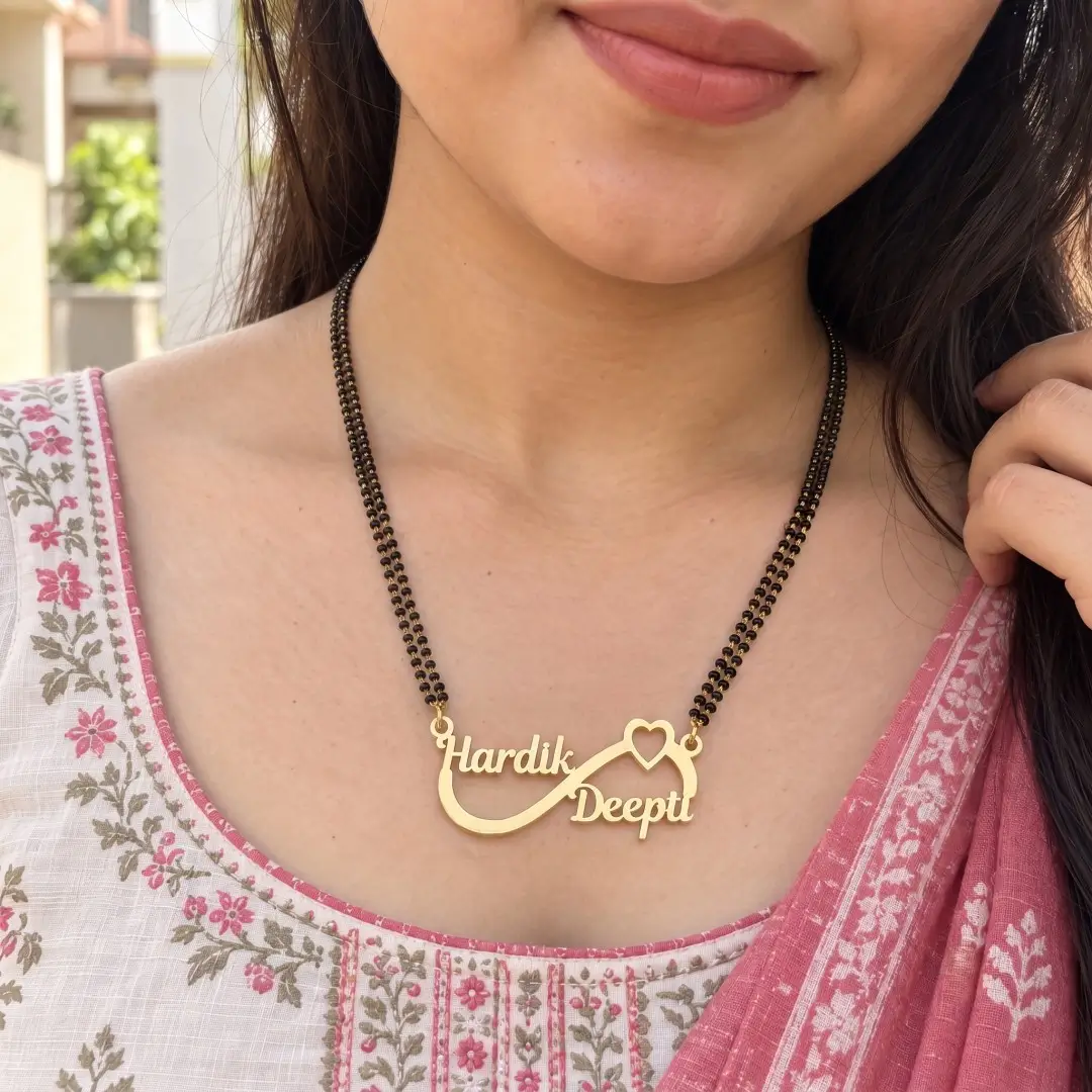 Infinity Heart Couple Name Mangalsutra Pendant - With a black-beaded chain shown on a model Infinity Heart Couple Name Mangalsutra Pendant with a black-beaded chain shown on a model