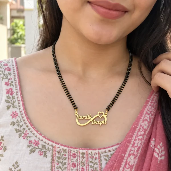 Hardik Deepti infinity double name necklace with black-bead chain worn with a floral outfit