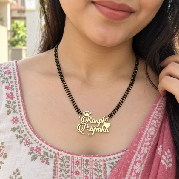 Diamond couple name necklace with black-bead chain worn with a floral outfit