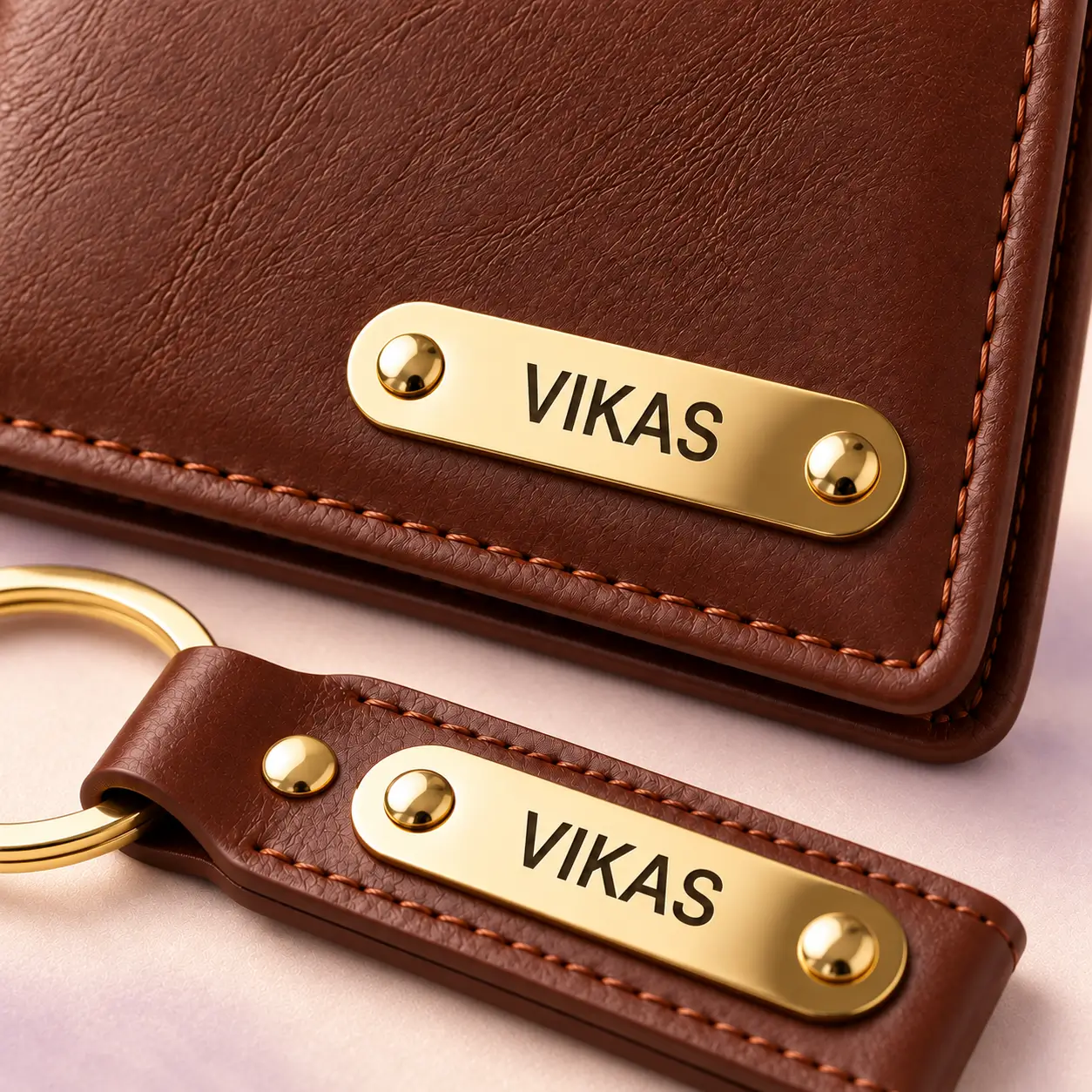 Brown Wallet and Keychain Combo - 2 Close-up of VIKAS name plates and stitching on the brown wallet and keychain