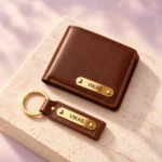 Personalized brown wallet and keychain displayed on a light stone surface