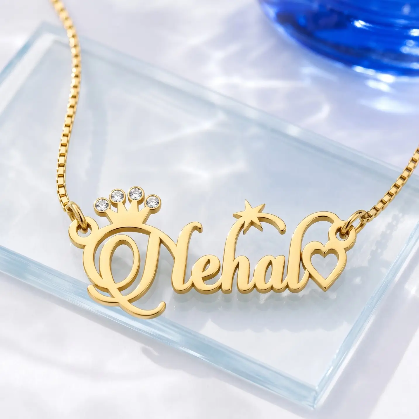 Sparkle Crown Name Necklace - Glass Display Gold-tone name necklace with a sparkling crown, star and heart on a clear glass display