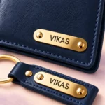 Close-up of VIKAS name plates and stitching on the navy blue wallet and keychain