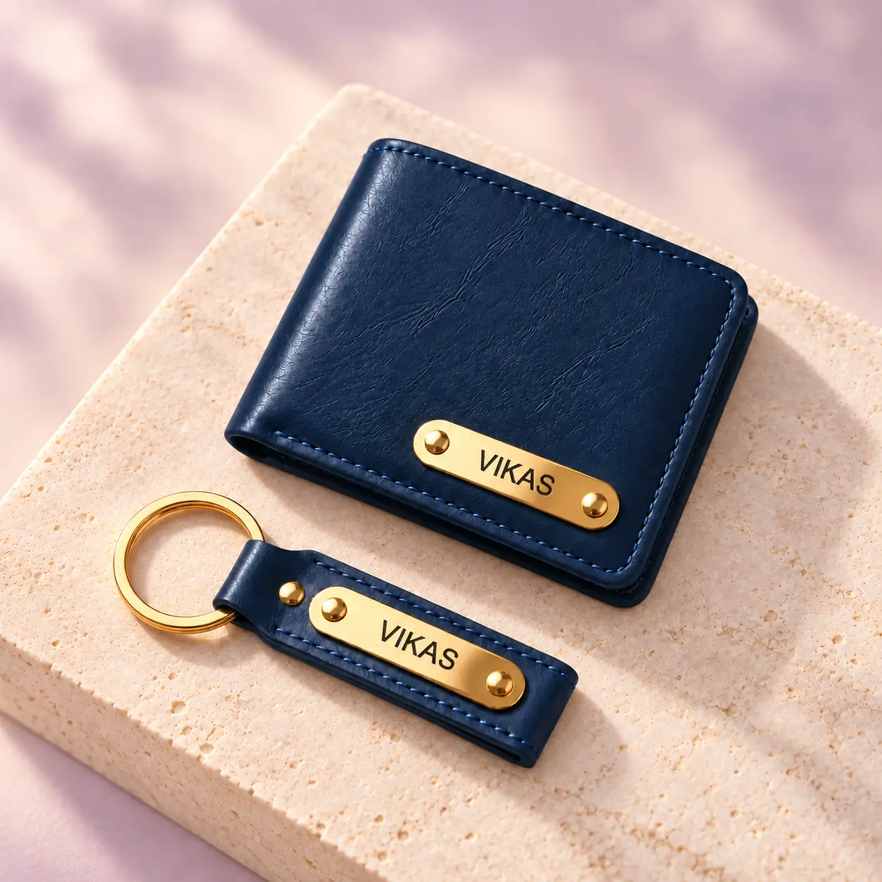 Navy Blue Wallet and Keychain Combo - 4 Personalized navy blue wallet and keychain displayed on a light stone surface