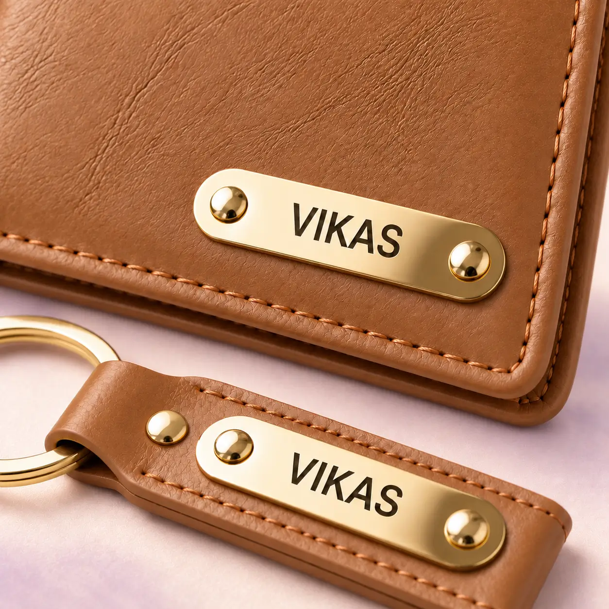 Tan Wallet and Keychain Combo - 2 Close-up of VIKAS name plates and stitching on the tan wallet and keychain