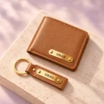 Personalized tan wallet and keychain displayed on a light stone surface