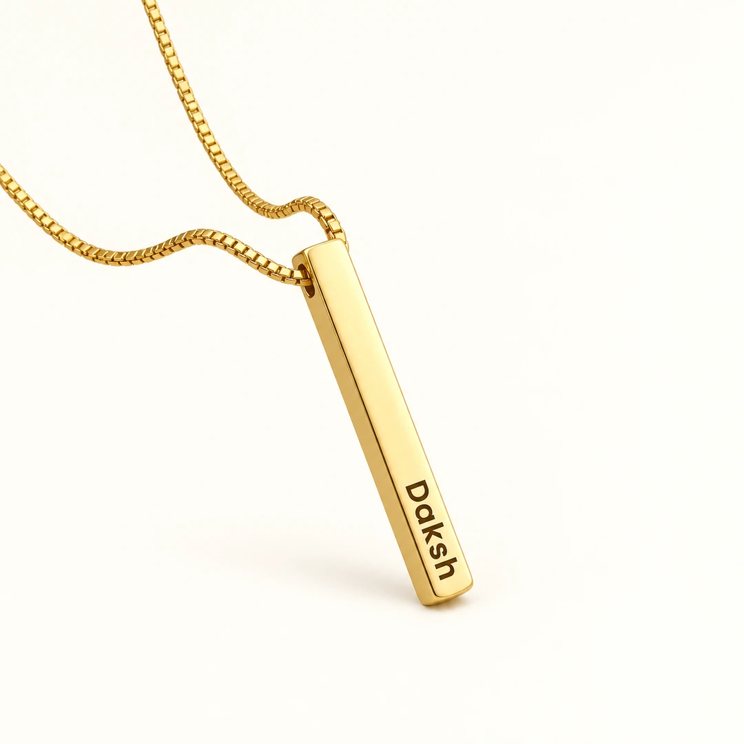 Gold Plated Personalized 3D Bar Pendant - clean ivory catalog photo Gold plated 3D bar pendant with Daksh engraving and gold box chain on ivory background