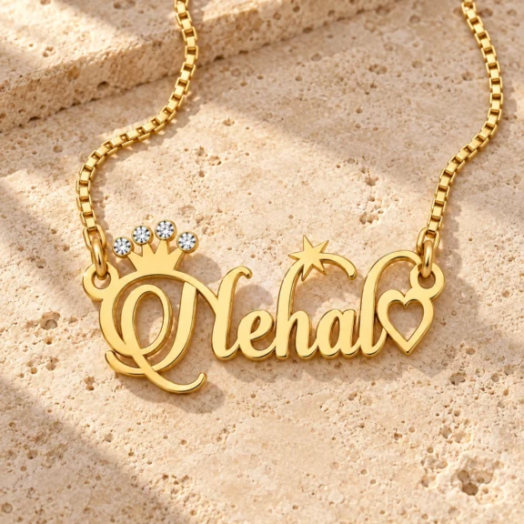 Sparkle Crown Name Necklace on a rough stone surface