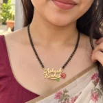 Red Rose Couple Name Necklace with a black-beaded chain worn with a sari