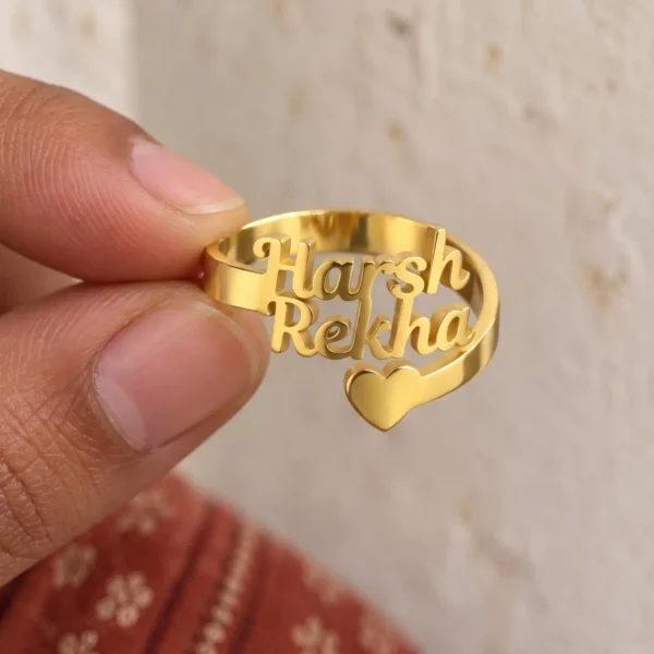 Forever Heart Couple Name Ring held between fingers to show the personalized design