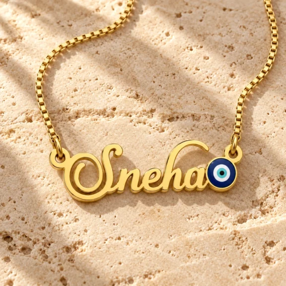 Blue Evil Eye Name Necklace on a rough stone surface