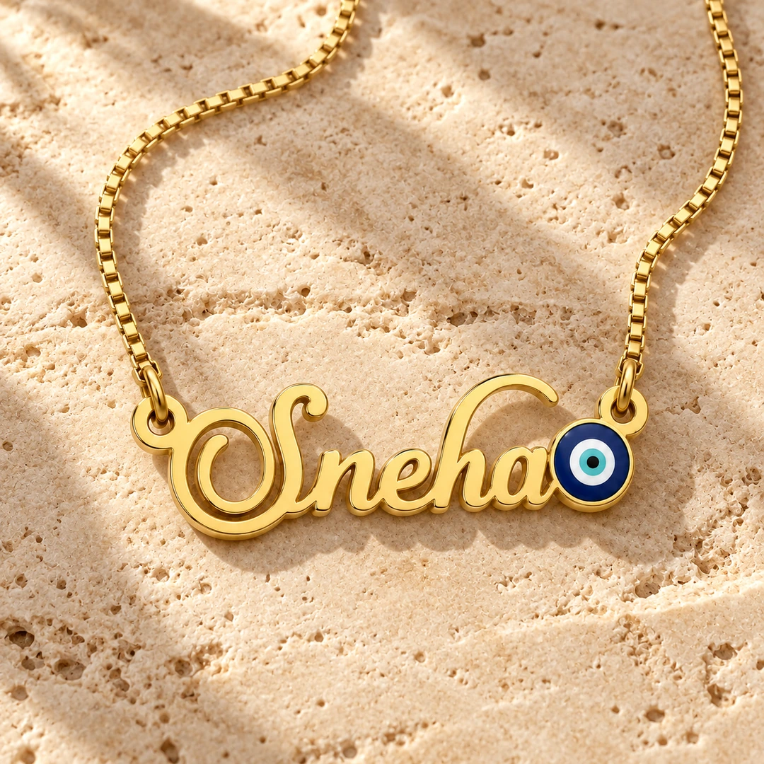 Blue Evil Eye Name Necklace - On a rough stone surface Blue Evil Eye Name Necklace on a rough stone surface