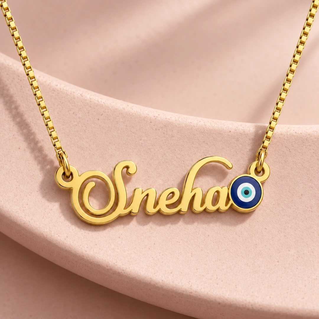 Blue Evil Eye Name Necklace - On a pink display Blue Evil Eye Name Necklace on a pink display