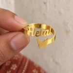 Personalized Butterfly Name Ring held between fingers to show the personalized design
