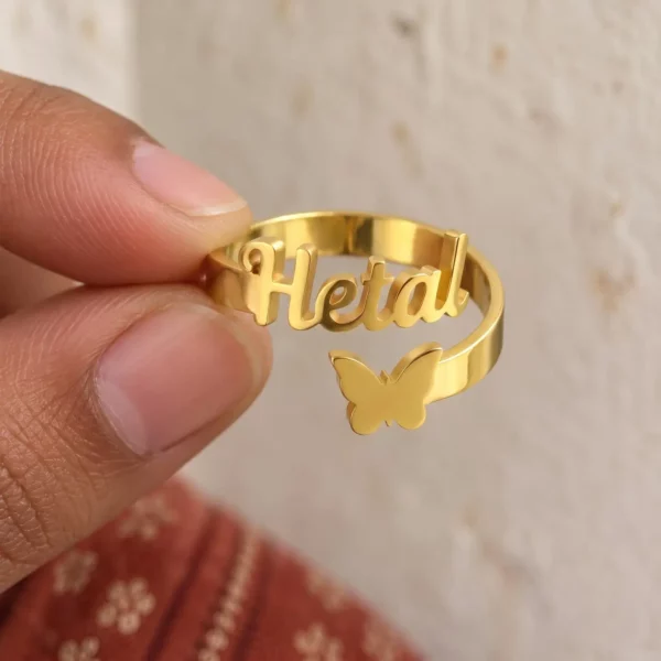 Personalized Butterfly Name Ring held between fingers to show the personalized design