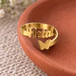 Personalized Butterfly Name Ring displayed on a terracotta dish