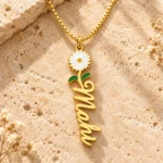 Flower Drop Name Necklace on a rough stone surface