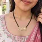Custom infinity couple name necklace with black bead chain worn with a floral outfit