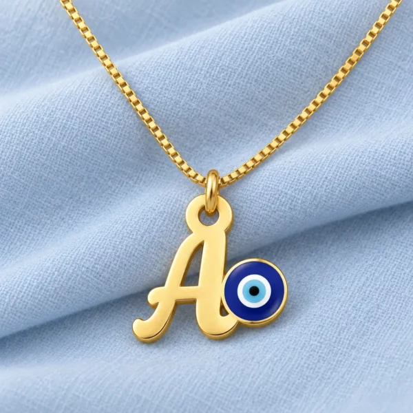 Blue Evil Eye Letter Pendant displayed on pale blue fabric