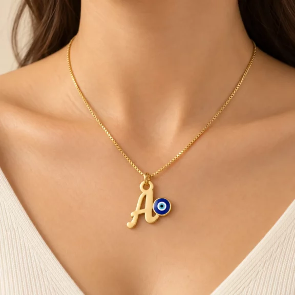 Blue Evil Eye Letter Pendant worn on a fine chain