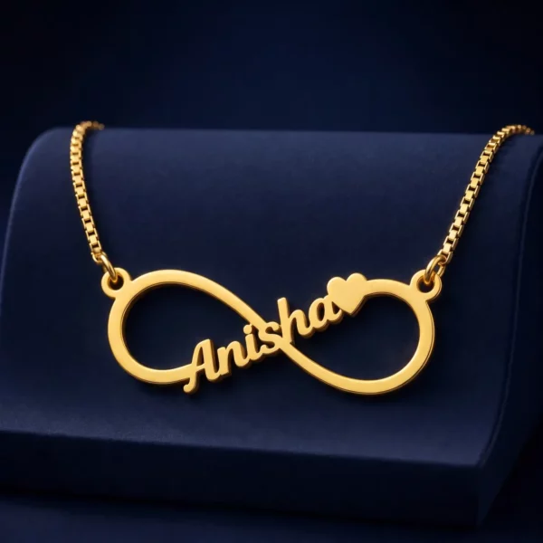 Gold-tone infinity outline name necklace on a navy velvet display