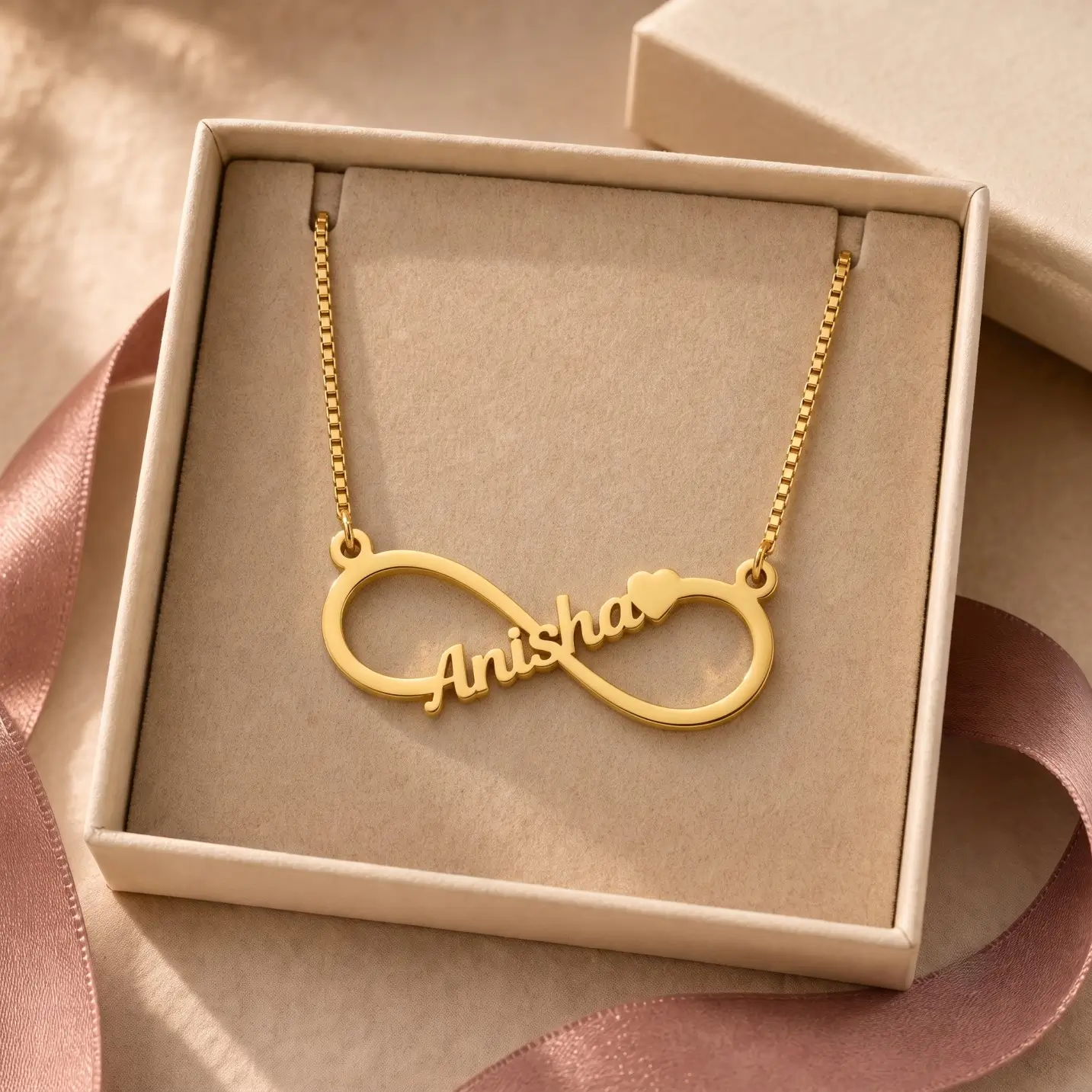 Personalized Infinity Name Necklace - Jewellery Box Gold-tone infinity outline name necklace displayed in an open beige jewellery box