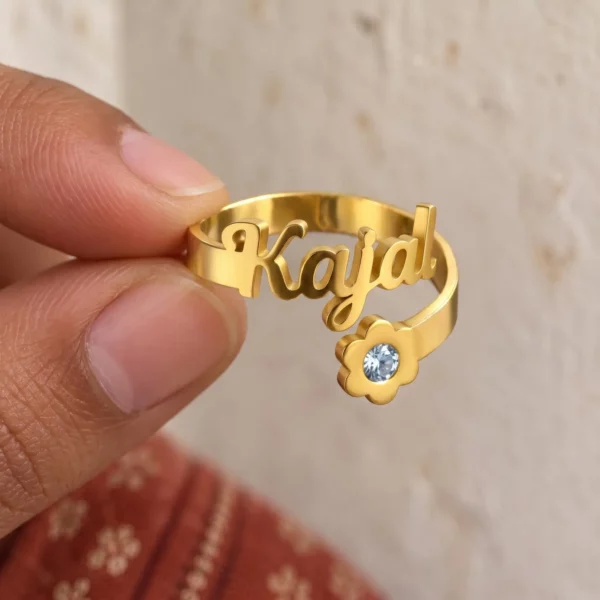 Personalized Shiny Flower Name Ring held between fingers to show the personalized design