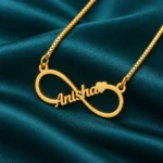 Personalized Infinity Name Necklace on dark green fabric