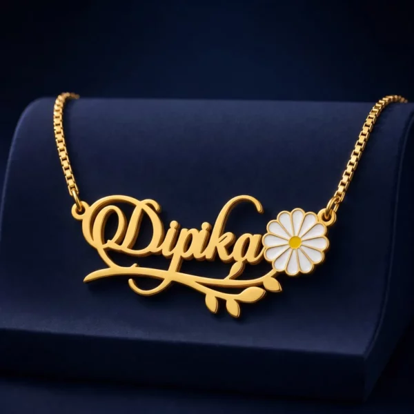 Gold-tone daisy and leaf name necklace on a navy velvet display