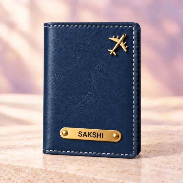 Blue personalized passport cover with a golden nameplate and airplane detail, front view