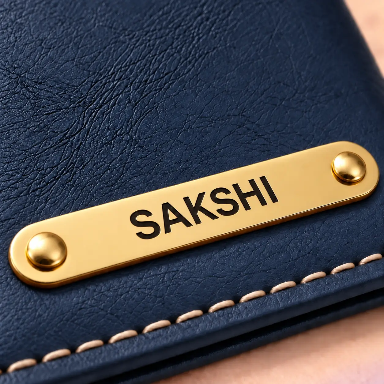 Personalized Blue Passport Cover - Nameplate Detail Close-up of the custom nameplate and stitching on a blue passport cover
