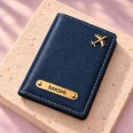Blue custom name passport cover viewed at an angle on a stone display