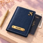 Blue personalized passport cover beside travel documents and a pen