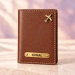 Brown personalized passport cover with a golden nameplate and airplane detail, front view
