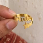 Personalized Star Name Ring held between fingers to show the personalized design